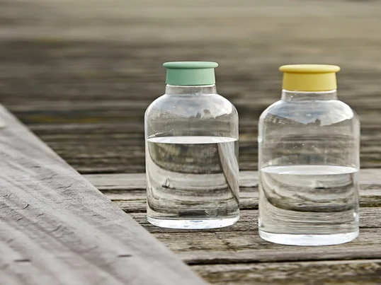 De Drink-It waterfles van Rig-Tig by Stelton in geel en stoffig groen in het sfeerbeeld. De schroefdeksel is verkrijgbaar in verschillende kleuren.