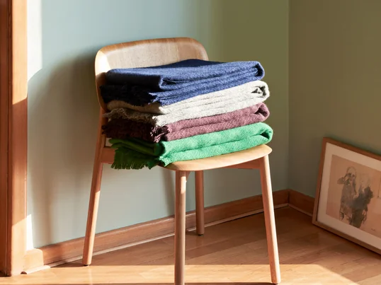 De Mono wollen deken van Hay in het sfeerbeeld: de zachte deken met de speelse franjes is een echte blikvanger en biedt voldoende warmte op koude dagen.