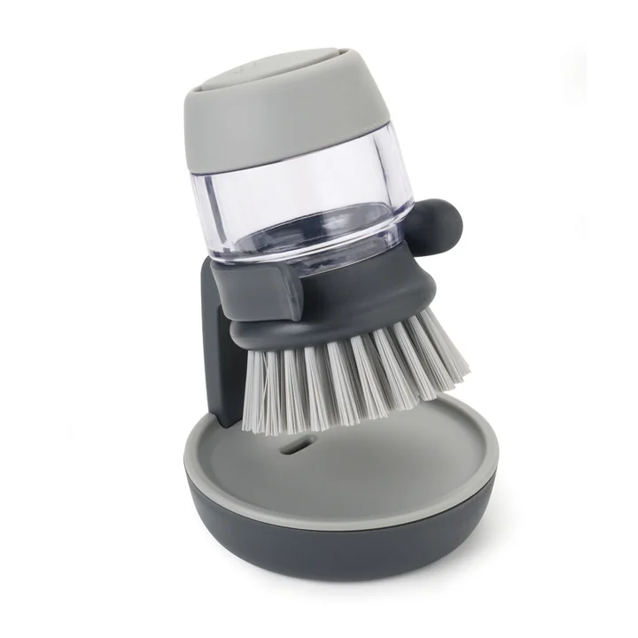 Palm Scrub Gootsteenborstel met wasmiddeldispenser van Joseph Joseph in grijs