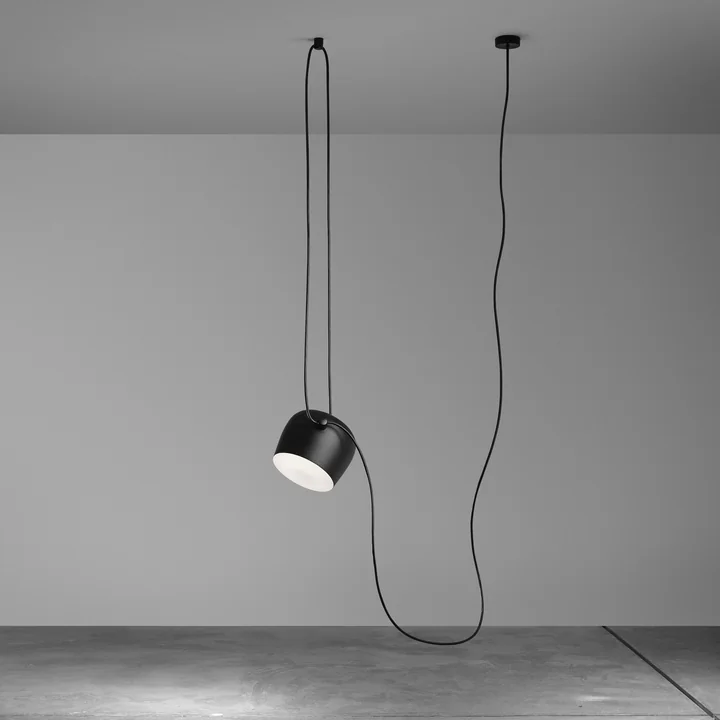 De AIM hanglamp, zwart van Flos in een lege kamer