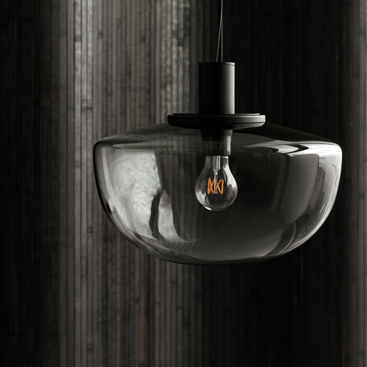 Bank hanglamp van Audo voor een donkere betonnen muur