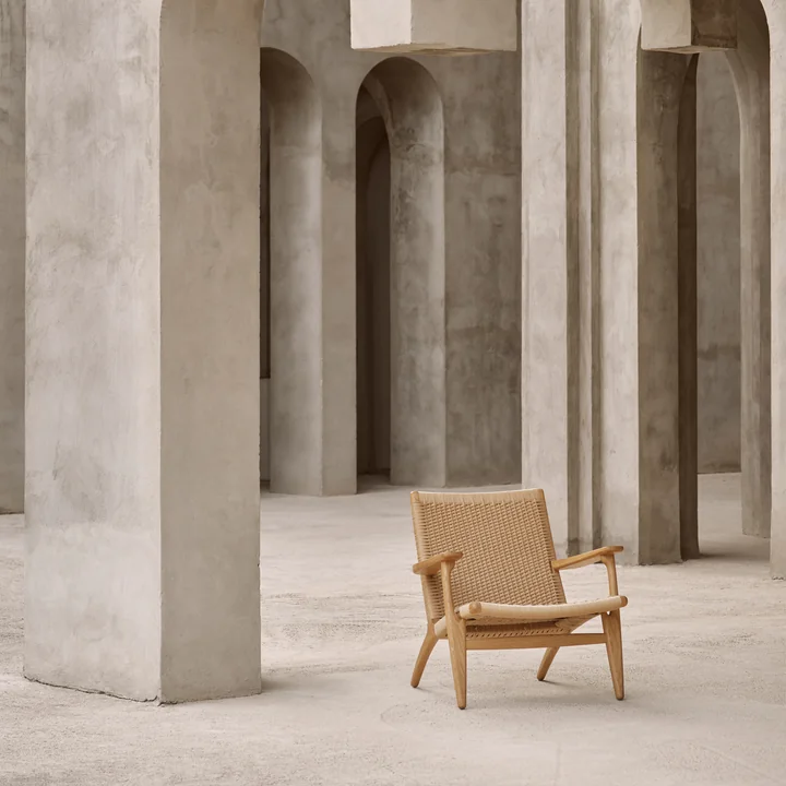 De gezellige CH25 fauteuil van Carl Hansen te midden van stenen muren