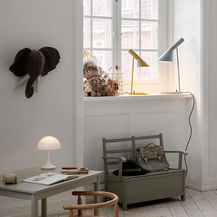 De AJ tafellamp van Louis Poulsen op een vensterbank in de kinderkamer