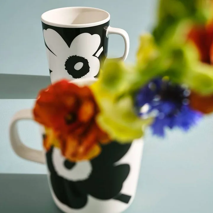Het Unikko-patroon van Marimekko op twee zwart-witte mokken